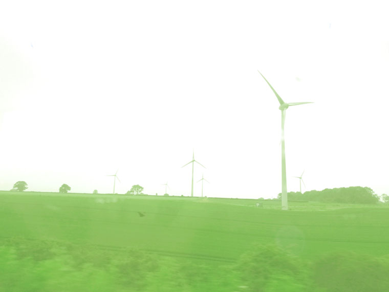 Windmills in UK Green landscape representing the madness of seeking your dreams